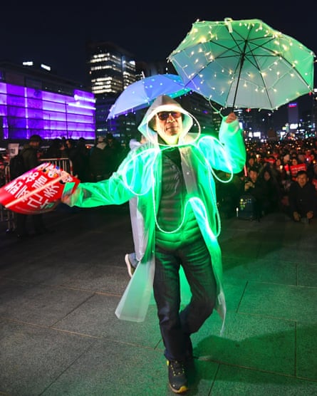 A man in an illuminated costume at a rally in Seoul demanding the arrest of Park Geun-hye.