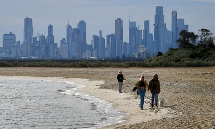 AUSTRALIA-HEALTH-VIRUSPeople enjoy a mid-winter walk on Brighton Beach in Melbourne on June 22, 2021 as the city’s latest Covid-19 outbreak recedes while Sydney battles a fresh cluster, highlighting Australia’s difficulty in quashing persistent small virus flare-ups. (Photo by William WEST / AFP) (Photo by WILLIAM WEST/AFP via Getty Images)