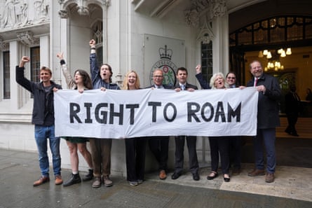 Campaigners celebrate holding a sign reading ‘Right to Roam’