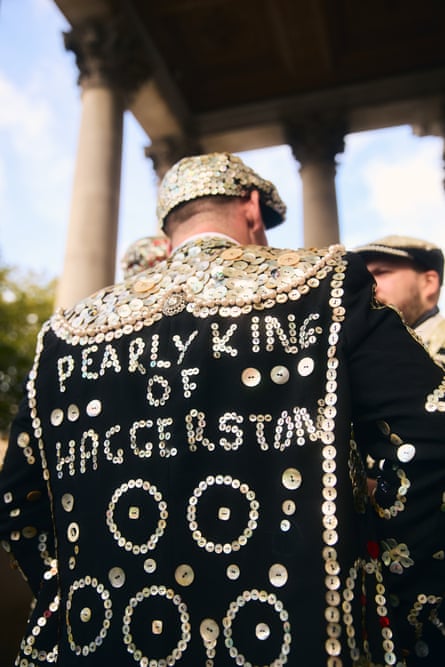 Michael Goodwin with his back to camera so you can see ‘pearly king of Haggerston’ written on his back