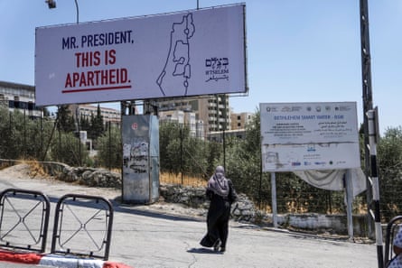 A billboard says “Mr. President, this is apartheid”