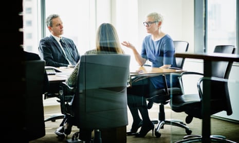 Female business executive leading meeting in office conference room