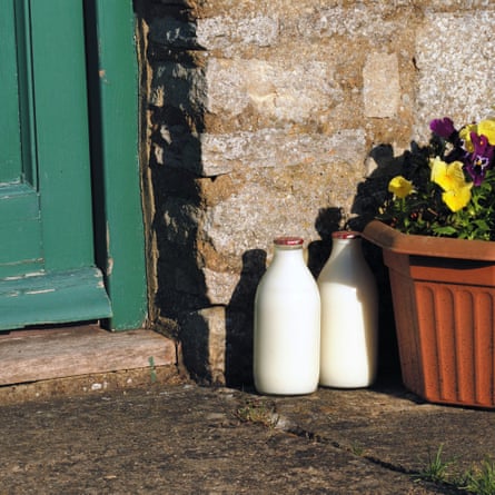 Two milk bottles on doorstep in morning sun