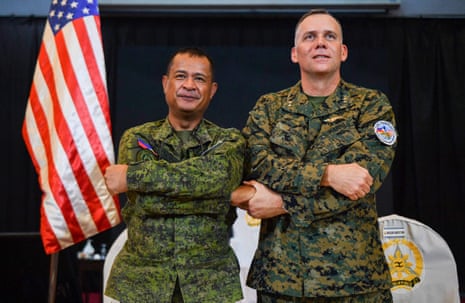 Philippine exercise director Major General Marvin Licudin, left, and US exercise director Major General Eric Austin link arms during the opening ceremony of the 'Balikatan' joint military exercise in Manila on Tuesday.