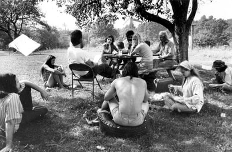A group of people sit outside in a black and white image