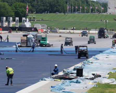 Workers apply a blue protective coating as part of a renovation project on the Lincoln Memorial reflecting pool in Washington DC on Friday.