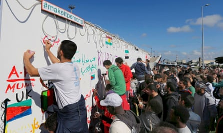 Migrants leave messages on a wall fresco in Calais. More than 3,000 people fleeing war and poverty in the Middle East, Africa and Asia now live in makeshift camps at the port.