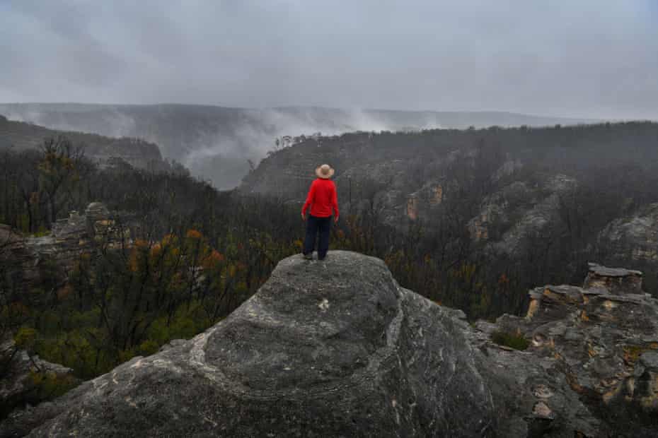 Madi Maclean overlooks the landscape, still visibly scared by the Black Summer bushfires down into the Wolgan Falls.