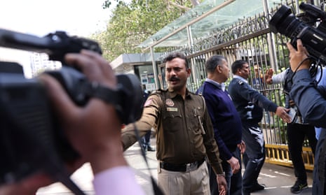 Police officers hold back news crews during the raid by tax officials on the BBC’s offices in Delhi on Tuesday.