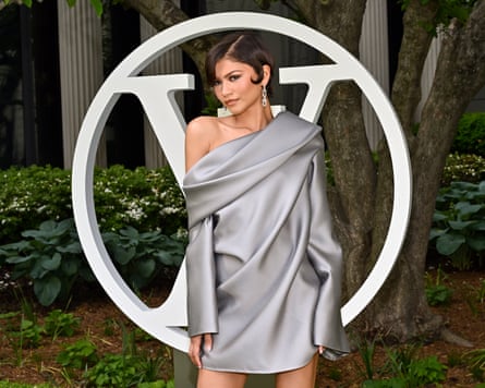Zendaya poses in front of a huge LV logo