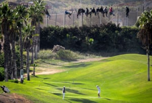 People try to cross into Spain’s north African enclave of Melilla from Morocco in October 2014.