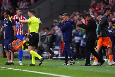 Diego Simeone celebrates after referee Danny Makkelie says no penalty.