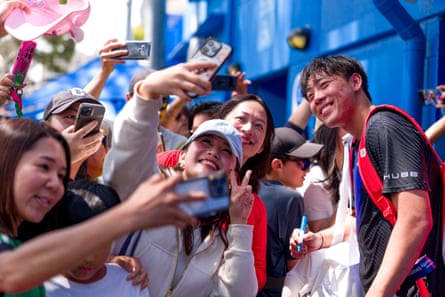 Fans take selfies with Coleman Wong after his victory against Pablo Llamas Ruiz in qualifying this week