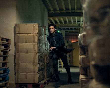 Man runs past pallet of cardboard boxes