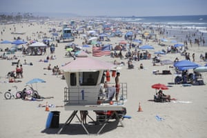 California, USA lifeguard keeps watch over a packed beach Saturday, in Huntington Beach