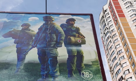 An advertising board, promoting service in the Russian army and inviting volunteers to sign up, seen near an apartment block that was damaged in a reported drone attack on Moscow on 30 May 2023.
