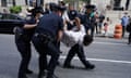 police officers arrest a protester