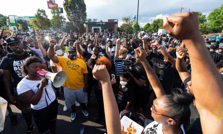 Protesters rally in the street in front of a Wendy’s restaurant destroyed amid protests over the police shooting of Rayshard Brooks, whose death has been ruled a homicide.