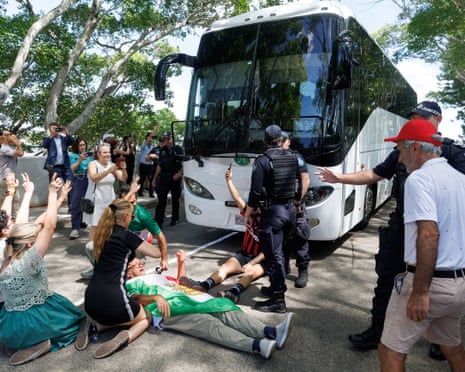 Protesters demonstrate outside of the hotel as a bus carrying players from the Iranian women’s soccer team and staff departs on Tuesday