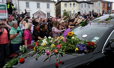 Flowers thrown on the bonnet of the hearse.