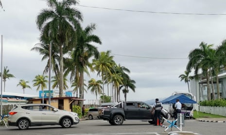 Police check cars at a checkpoint on a crossroad in Suva, Fiji. The government has imposed serious restrictions, including lockdowns and curfews, and police have made a large number of arrests.