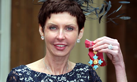 Denise Coates poses with her CBE medal.