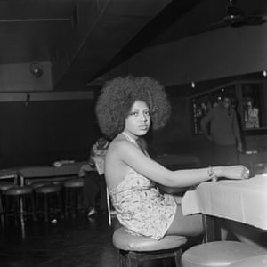 A woman waits at a contest, 1970s.