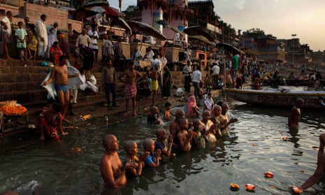 Hindu pilgrims in Varanasi gather for prayers and ritual bathing in the Ganges river.