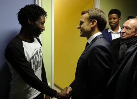President Macron shakes hands with Ahmed Adam