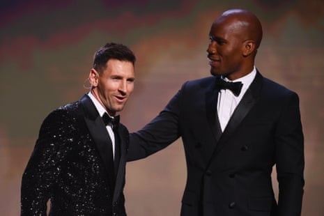 Host Didier Drogba congratulates Paris Saint-Germain’s Lionel Messi after he was awarded the Ballon d’Or, the seventh time he’s taken the title.