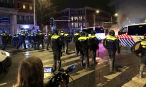 Riot police officers stand in position in a street of The Hague during a demonstration against the Dutch government’s coronavirus measures