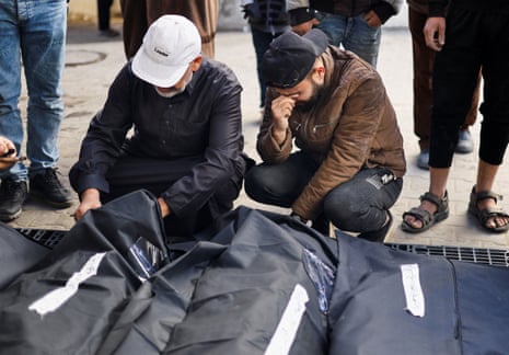 Palestinians mourn those killed in an Israeli strike in Rafah in the southern Gaza Strip, 25 March.
