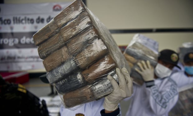 Police officers seize packages of cocaine at the airport in Lima in 2014.