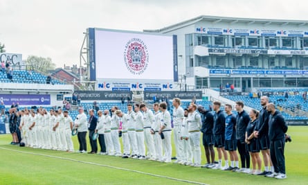 Yorkshire and Glamorgan players observe the national anthem at Headingley.