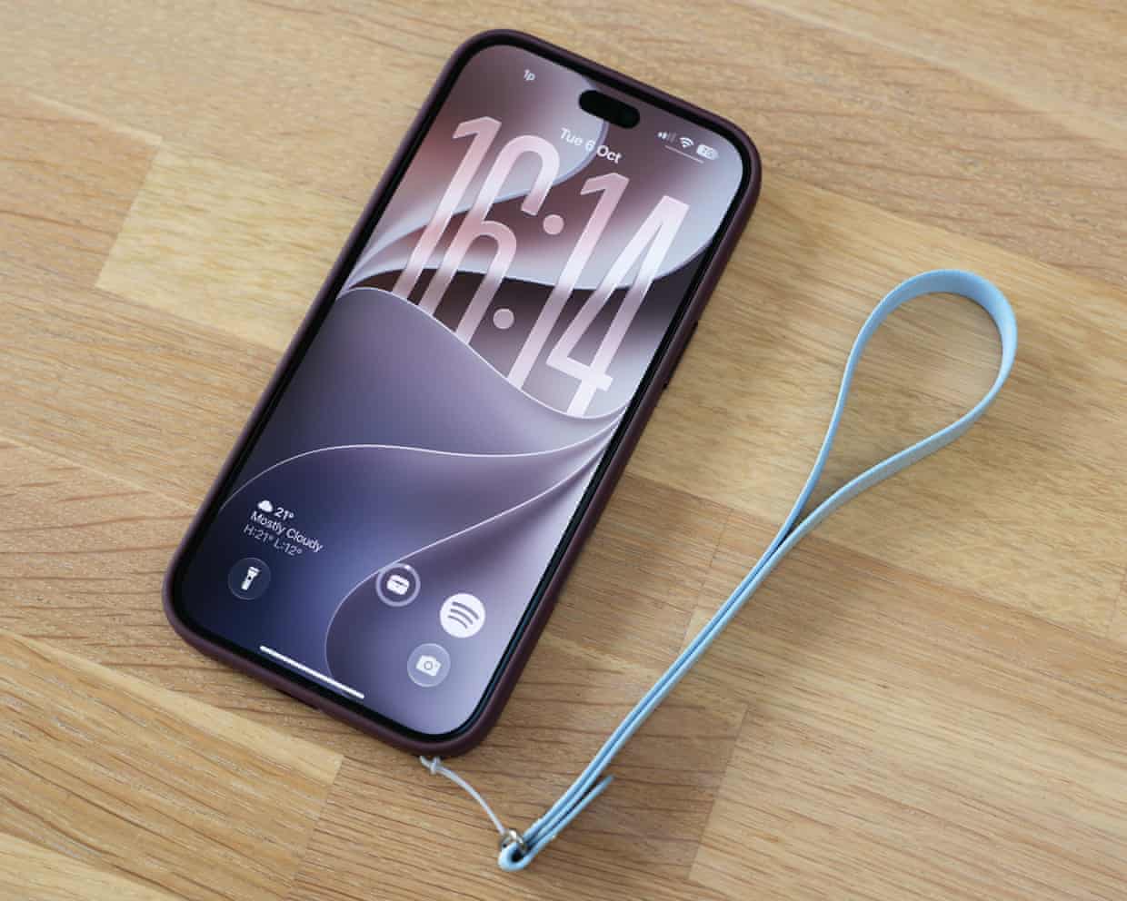 The iPhone 18 Pro Max in a case with a hand strap attached