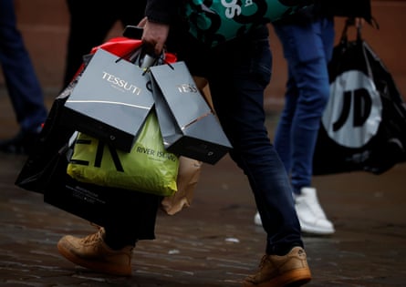 Shoppers carry bags at the start of the Boxing Day sales in 2020