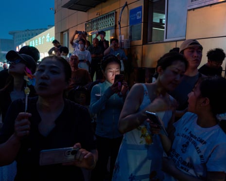 Residents wait outside the airport to catch a glimpse of Air Force One, the plane of the US president.