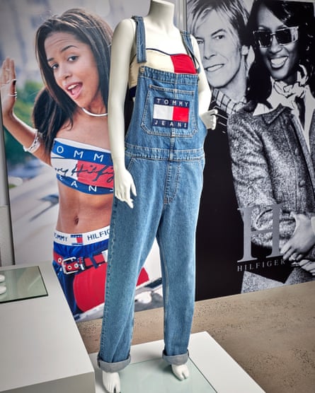 A pair of Tommy Jeans at the Hilfiger archive, in front of campaigns with Aaliyah, and David Bowie and Iman.
