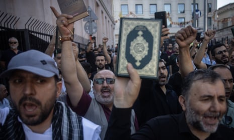 People hold copies of the Qur’an during a protest outside the Swedish consulate in Istanbul, Turkey, on Sunday.