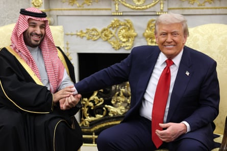 Donald Trump takes the hand of the Saudi crown prince, Mohammed bin Salman, during a meeting at the White House.