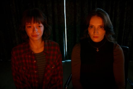 Laurie Babin, left, and Juliette Gariépy in Red Rooms. Two women look intensely at the camera, with a red filter. The one on the left is weeping