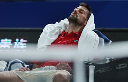Novak Djokovic rests during a break in his match against Jaume Munar