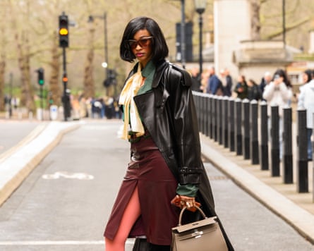 Racheal Broussard wearing a Saint Laurent coat, sunglasses and skirt, Hermes bag, Zara yellow blouse, vintage green top, pink tights and Mango shoes outside the Labrum show during London fashion week in February.