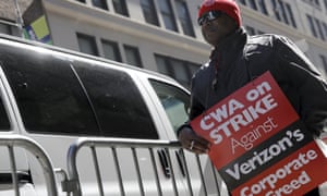 A member of the Communications Workers of America pickets in front of Verizon corporate offices during a 2016 strike in New York City.