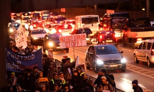 Participants of a demonstration walk through the streets in order to protest the fine dust pollution in Stuttgart, Germany, 21 November 2016.