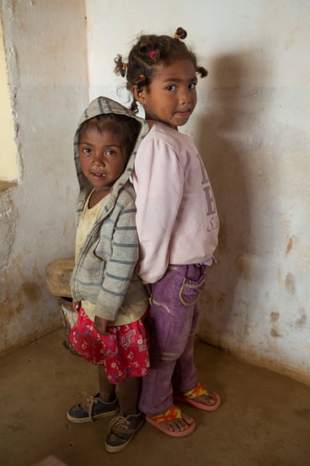 Rova, a chronically malnourished five-year-old girl, stands next to her friend Jiana Rakuturammambason