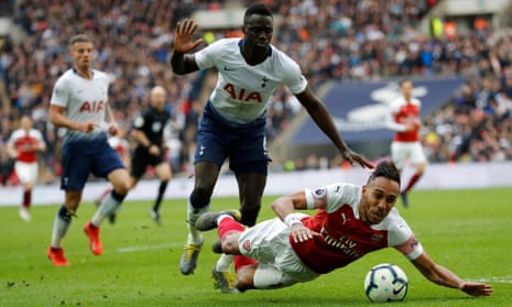 Arsenal’s Pierre-Emerick Aubameyang is fouled by Tottenham Hotspur’s Davinson Sanchez, giving away a penalty.