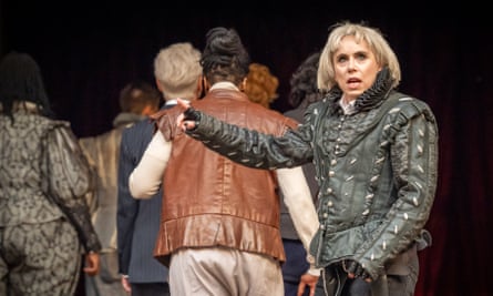 Terry in role wearing a black leather jacket. Other actors stand behind her with their backs to her.