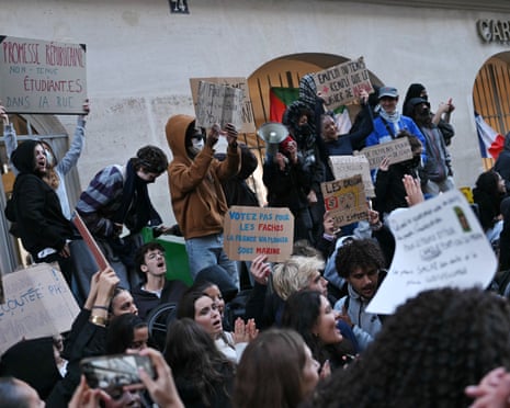 Students hold placards as they demonstrate outside the Carmes campus of the Institut Catholique de Paris (ICP), in Paris, France.