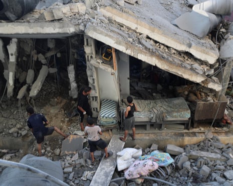 Palestinians inspect the site of an overnight Israeli airstrike on a house in Gaza City, 23 July 2025.